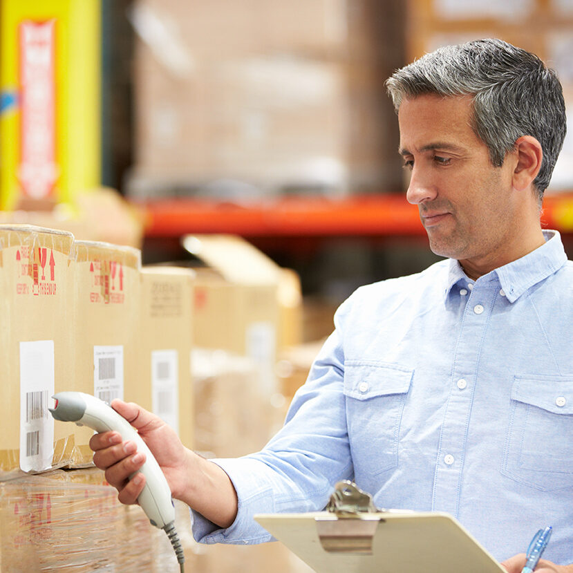 Worker Scanning Package In Warehouse